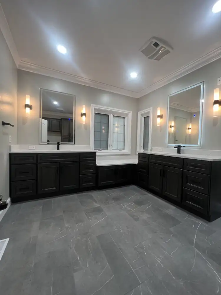 His-and-hers vanities with lighted mirrors and quartz tops