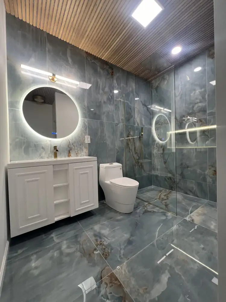 Bathroom remodel with onyx-look porcelain, floating vanity and backlit mirror, Amherst, Ohio