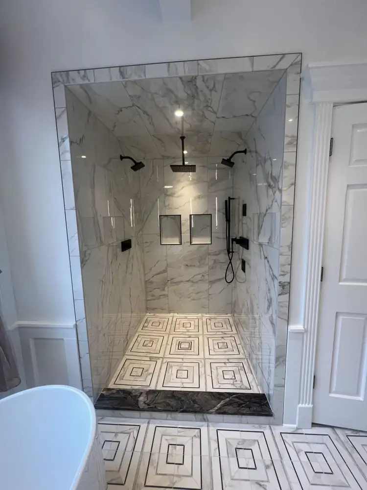 Another view: Freestanding tub under window, geometric marble-look mosaic floor, floating vanity with vessel sink, Bay Village, Ohio