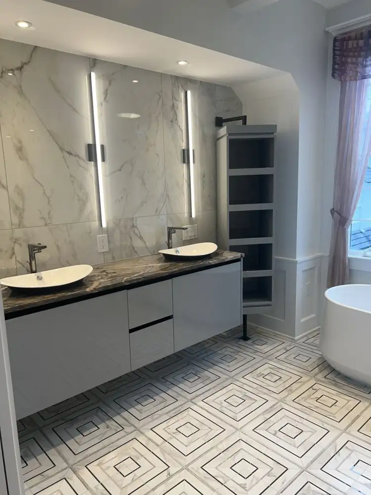 Another view: Freestanding tub under window, geometric marble-look mosaic floor, floating vanity with vessel sink, Bay Village, Ohio