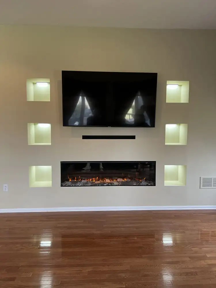 Custom media wall with built-in linear electric fireplace, wall-mounted TV and six lit display niches, Bedford, Ohio