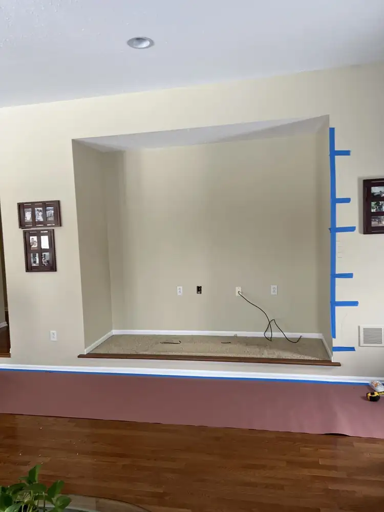 Carpeted TV alcove with outlets and cables before media wall build, Bedford, Ohio