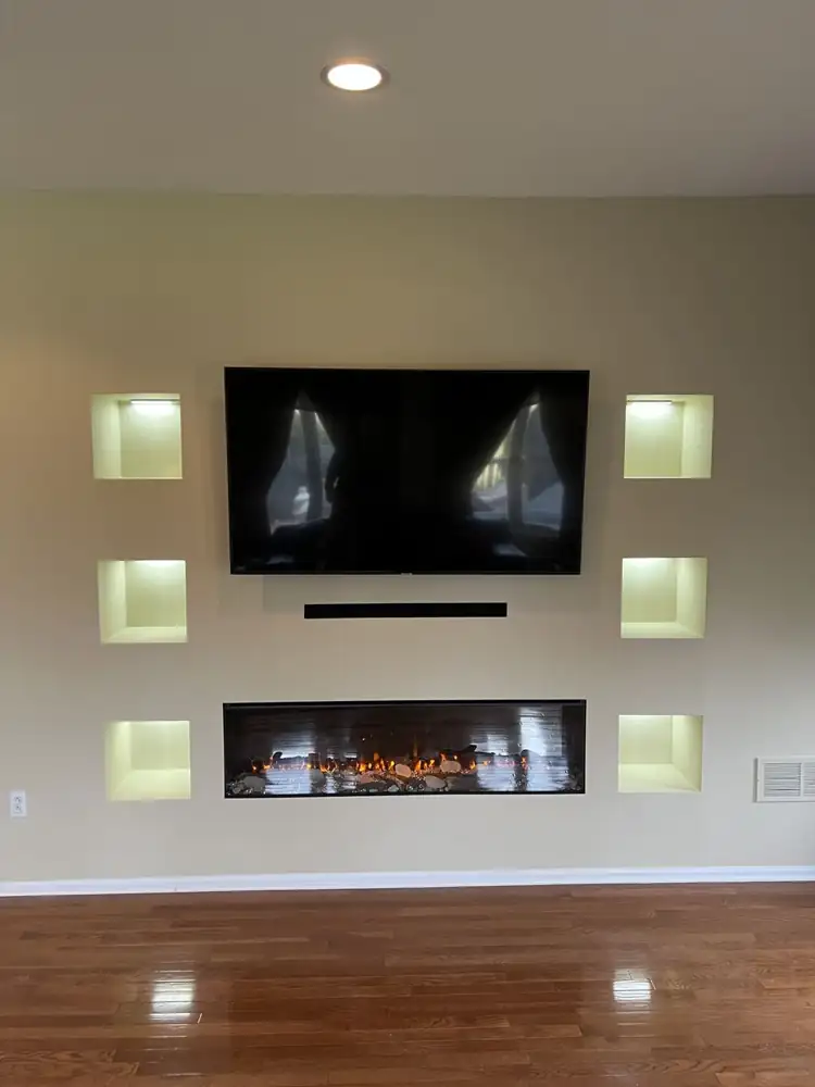 Another view: Custom media wall with built-in linear electric fireplace, wall-mounted TV and six lit display niches, Bedford, Ohio