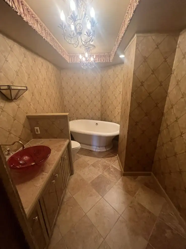 Dated bathroom with faux-finish walls and clawfoot-style tub before remodel, Bratenahl, Ohio