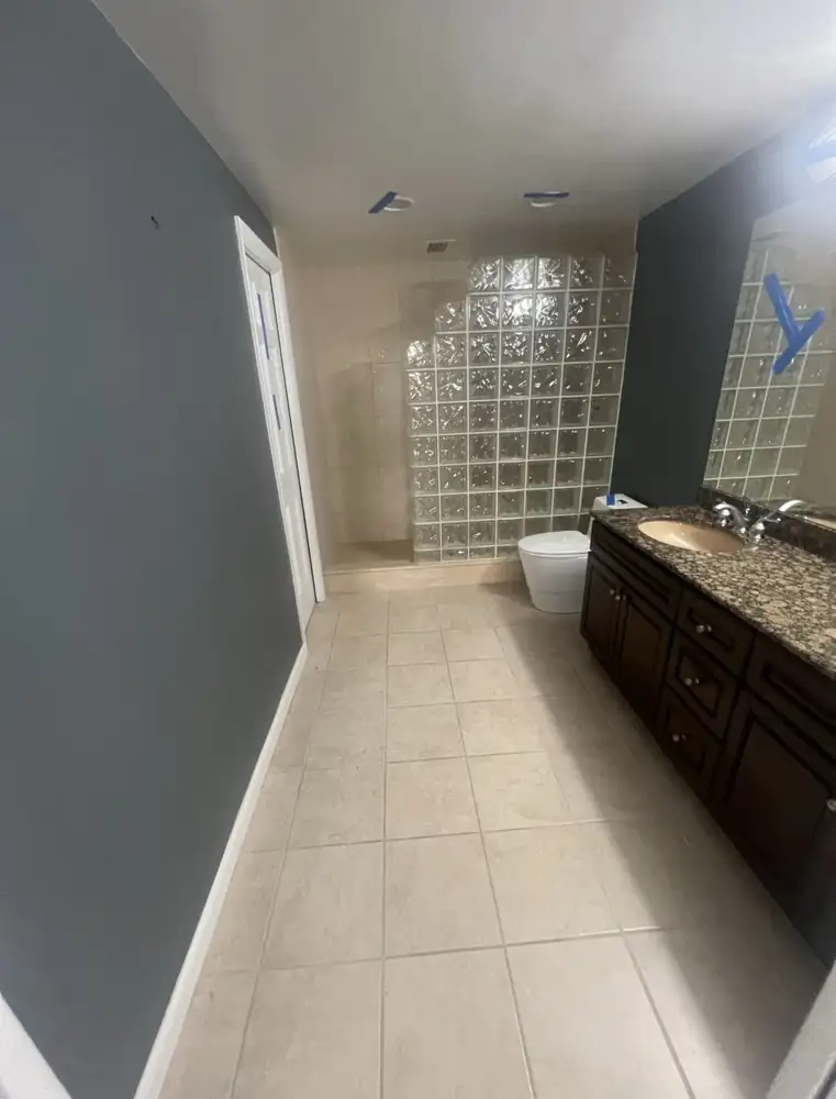 Bathroom with glass block shower and beige tile before remodel, Bratenahl, Ohio