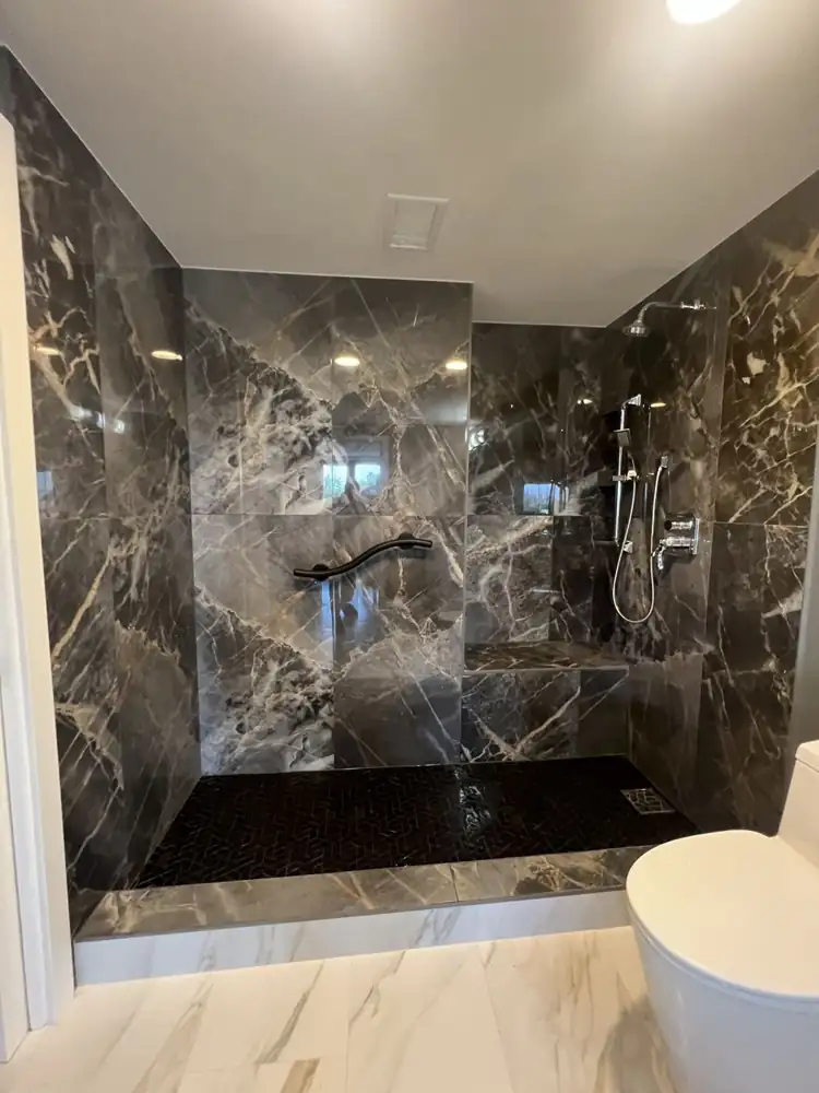 Walk-in shower with built-in bench, grab bar, handheld shower and herringbone mosaic floor, Ohio