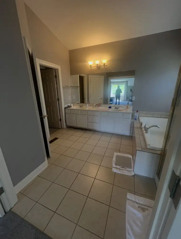 Primary bathroom with white double vanity, drop-in tub and beige tile before remodel, Brecksville, Ohio