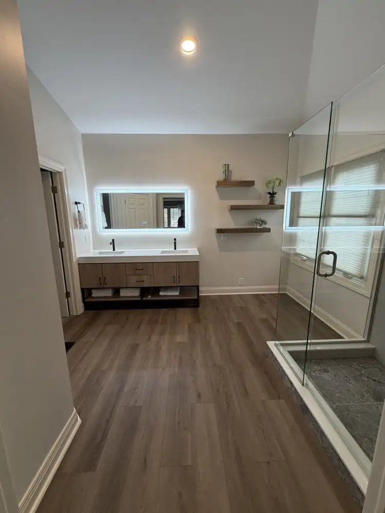 Another view: Floating wood double vanity with quartz top, lighted mirror, floating shelves and wood-look plank floor, Brecksville, Ohio