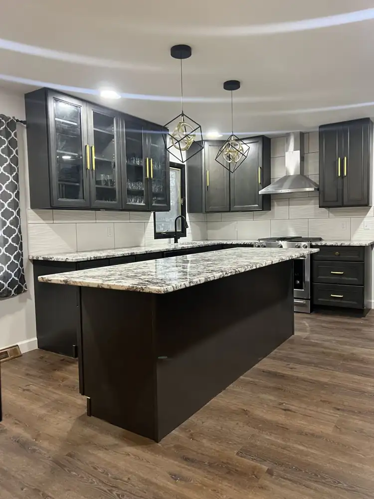 Granite kitchen island with pendant lights and glass-front cabinets