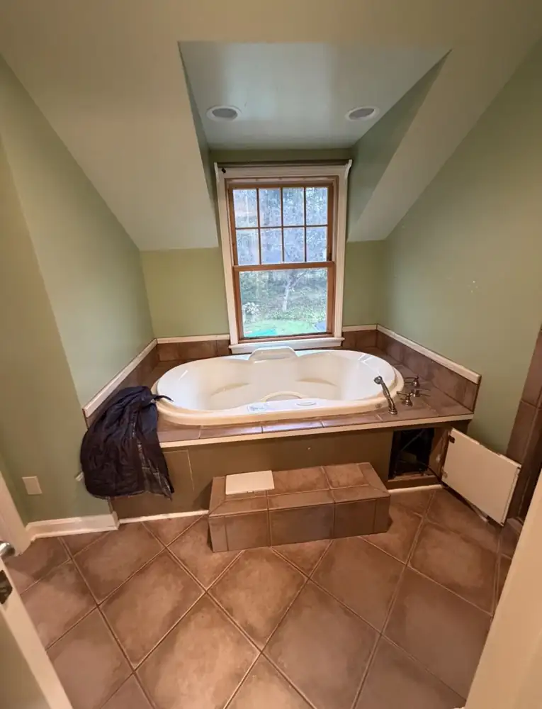 Dormer bathroom with tiled drop-in jetted tub platform before remodel, Chagrin Falls, Ohio