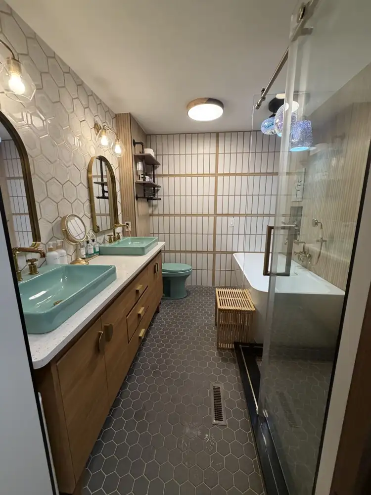 Another view: Bathroom with shoji-style tile wall, freestanding tub, glass shower with fluted wood-look tile, hex floor and turquoise fixtures, Chagrin Falls, Ohio