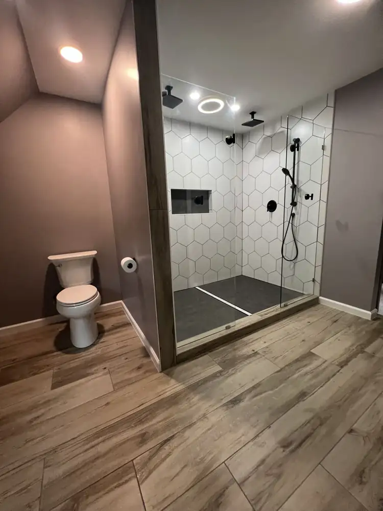 Bathroom with glass-enclosed double shower and wood-look tile floor, Hudson, Ohio