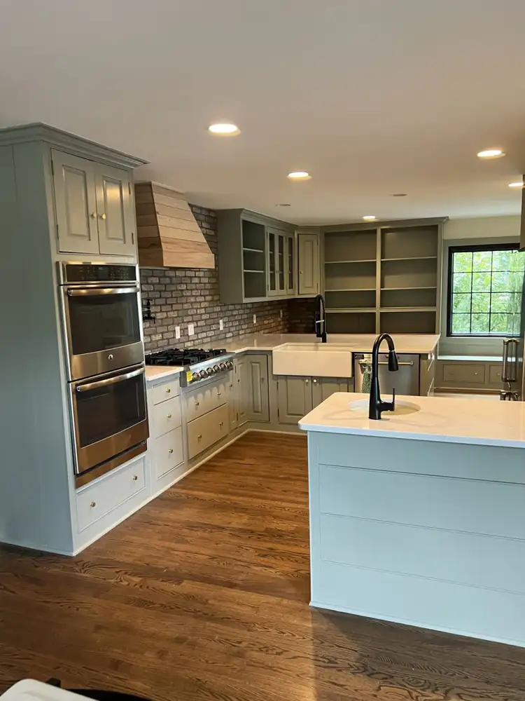 Kitchen with sage green cabinets and brick backsplash, Hudson