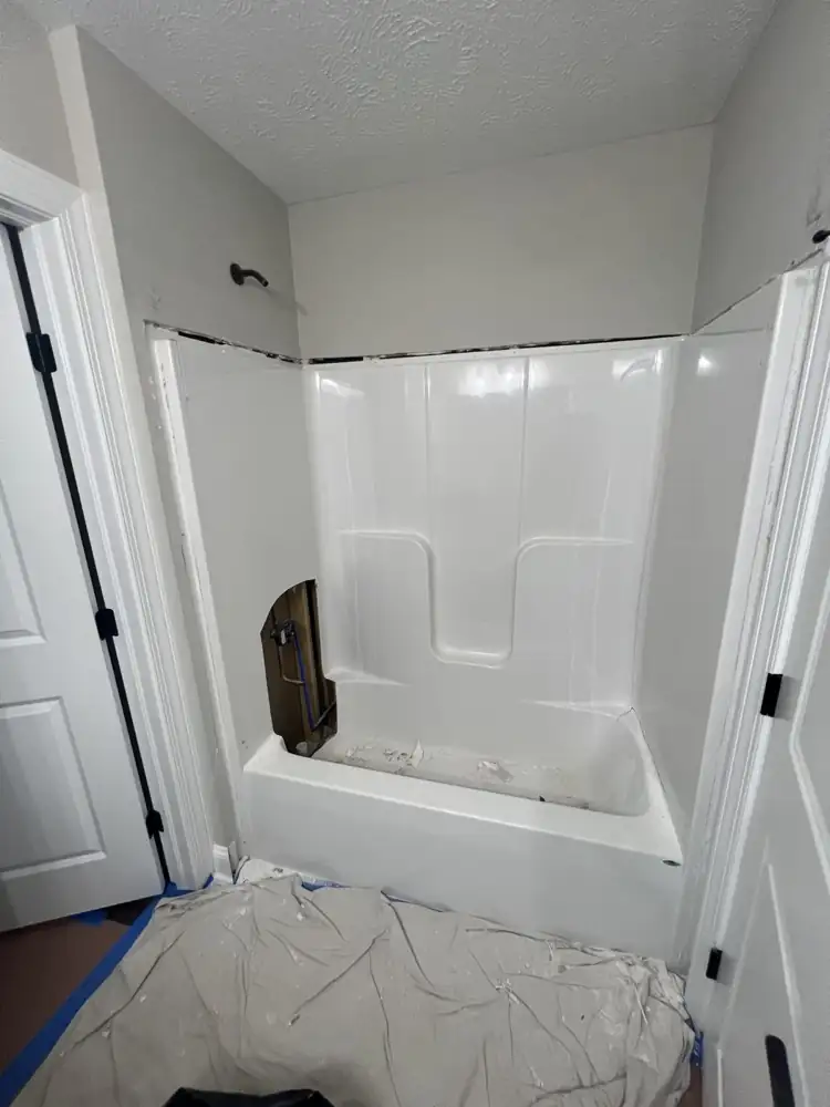 Cracked one-piece fiberglass tub surround before replacement, Macedonia, Ohio