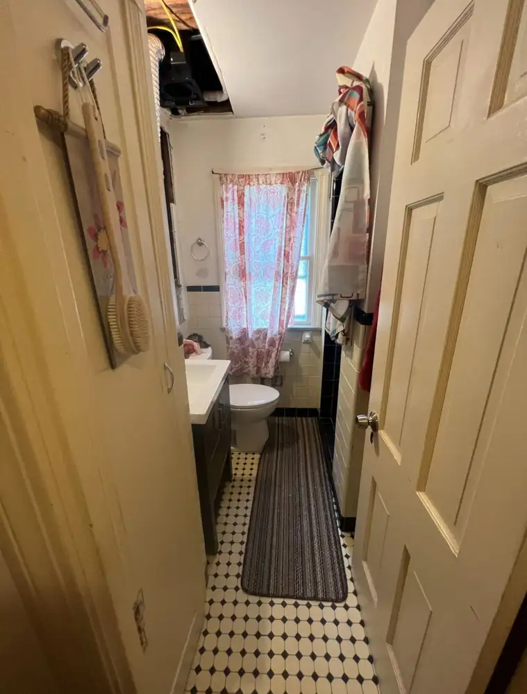 Small vintage bathroom with yellow wall tile and damaged ceiling before remodel, Mentor, Ohio