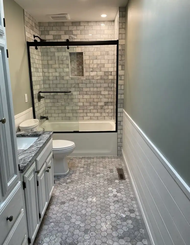 Bathroom with shiplap wainscot, marble subway tile tub surround and hex marble floor, Northeast Ohio
