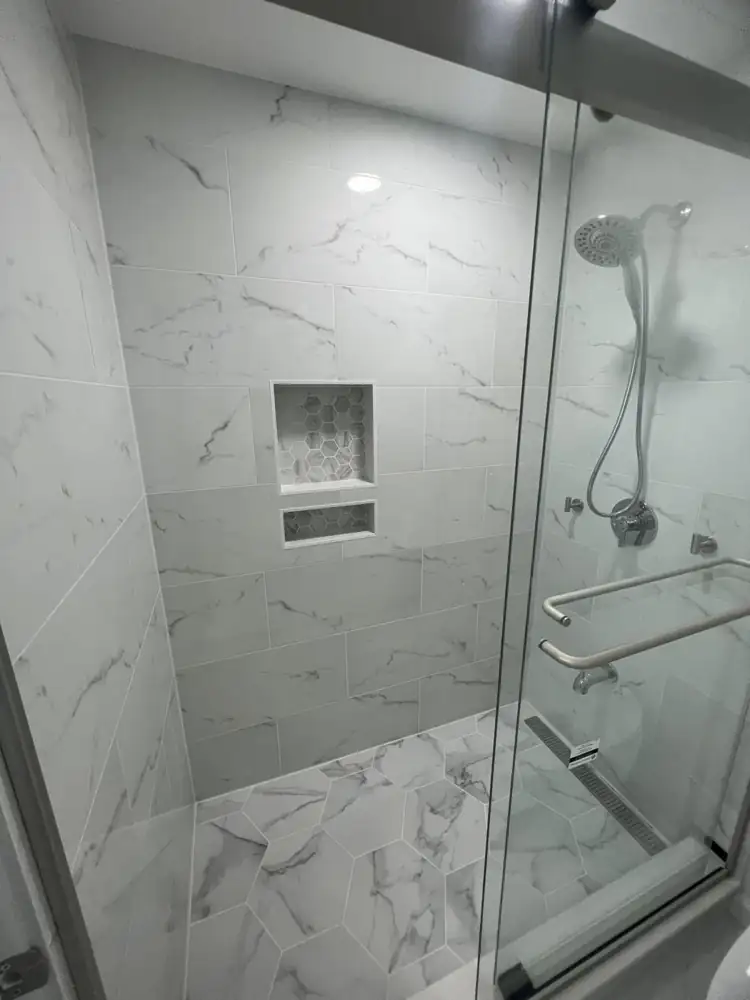 Marble-look porcelain shower with hex mosaic niches and handheld shower, Northeast Ohio