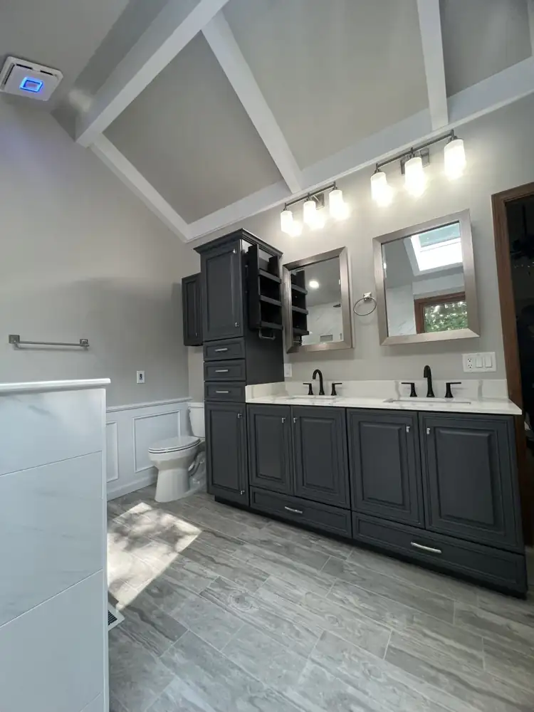 Charcoal double vanity with linen tower, quartz top, wainscoting and vaulted beamed ceiling, Northeast Ohio