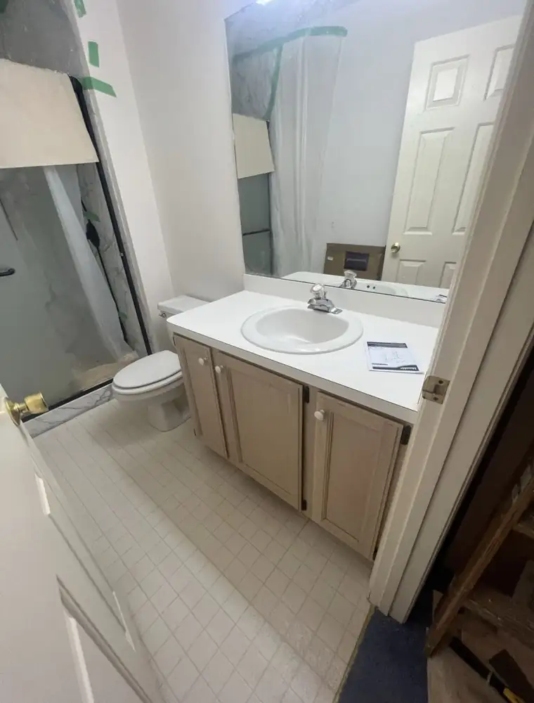 Bathroom with dated vanity, laminate top and vinyl floor before remodel, Northeast Ohio