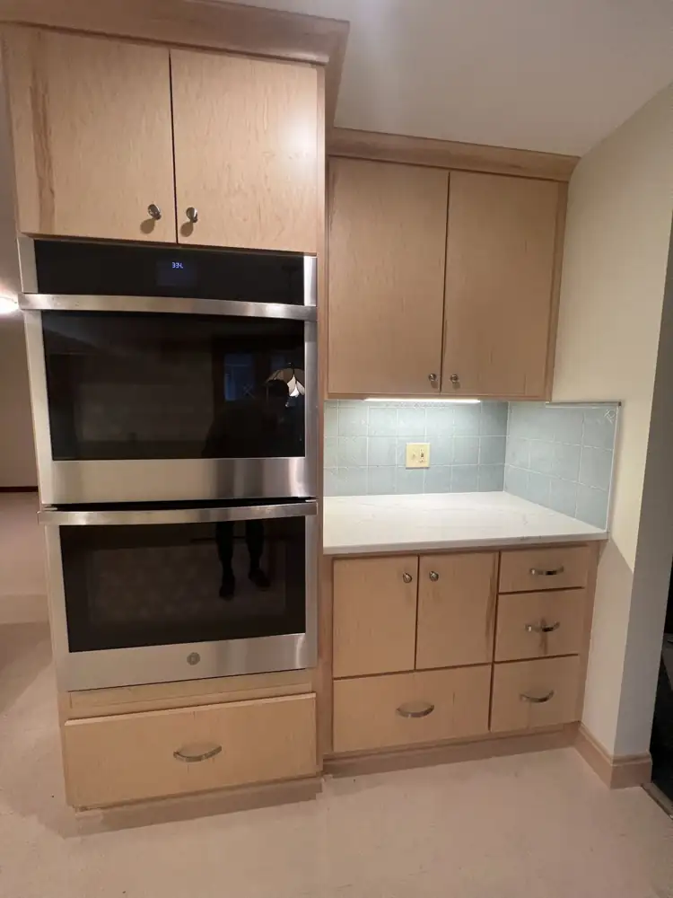 Double wall ovens in maple cabinetry with quartz counter and glass tile backsplash, Northeast Ohio