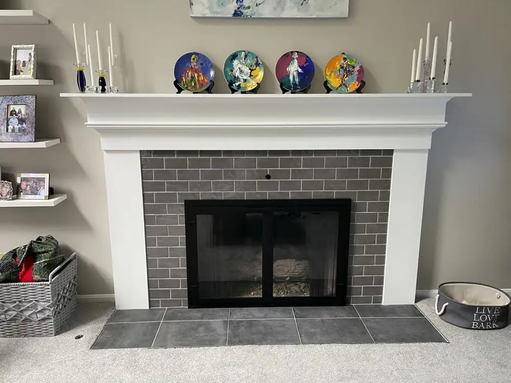 Fireplace with gray glazed subway tile surround, white mantel and large-format tile hearth, Northeast Ohio