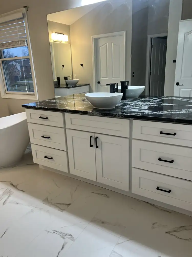 White shaker vanity with black and white granite top, vessel sinks and matte black faucets, Northeast Ohio