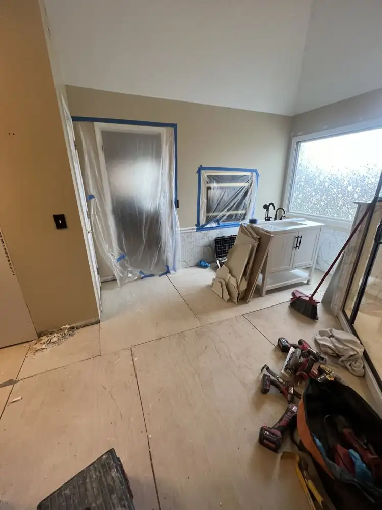 Primary bathroom stripped to new plywood subfloor during remodel, Northeast Ohio