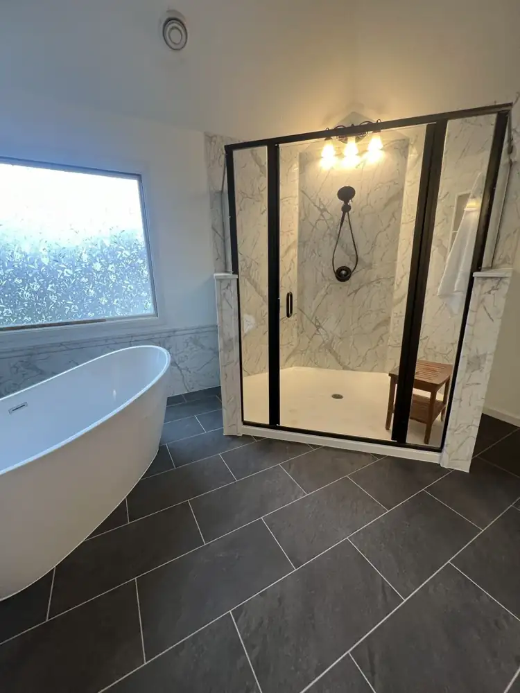 Walk-in shower with marble-look wall panels, black frame glass door and handheld shower, Northeast Ohio