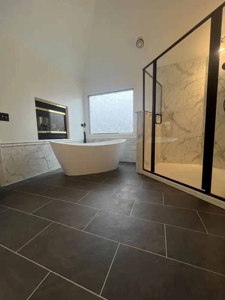 Charcoal porcelain floor laid in a staggered pattern through the primary bath, Northeast Ohio