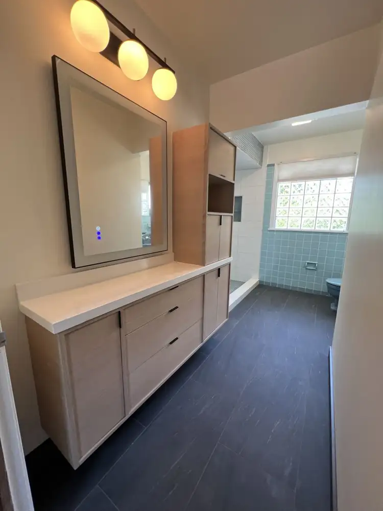Floating white oak vanity with tall cabinet, quartz top, lighted mirror and slate-look floor, Northeast Ohio