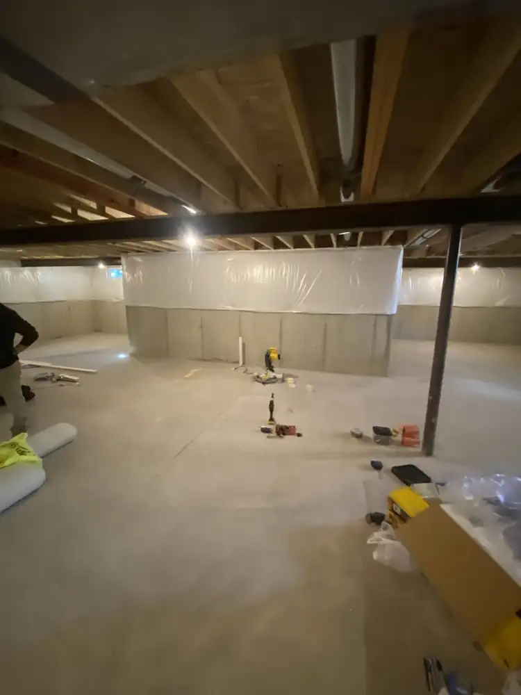 Unfinished basement with bare concrete walls and exposed joists before finishing, Northeast Ohio