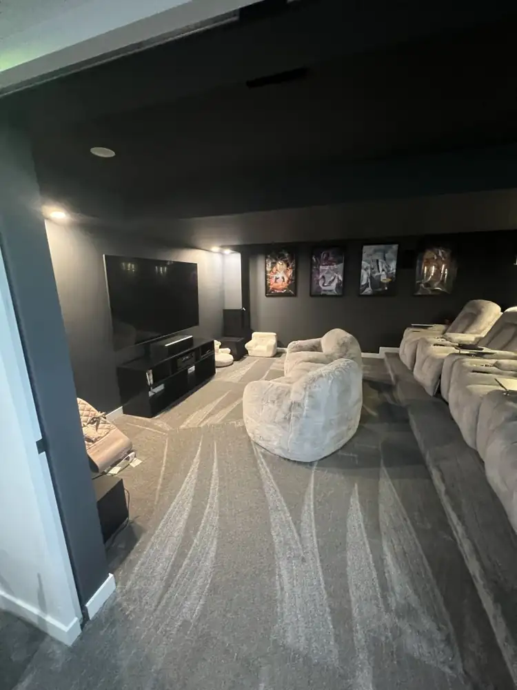 Basement home theater with black walls, stadium riser and recliner seating, Northeast Ohio