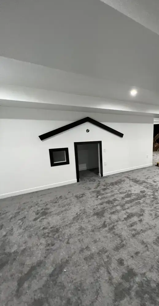Finished basement with a kids playhouse wall built into the drywall, Northeast Ohio