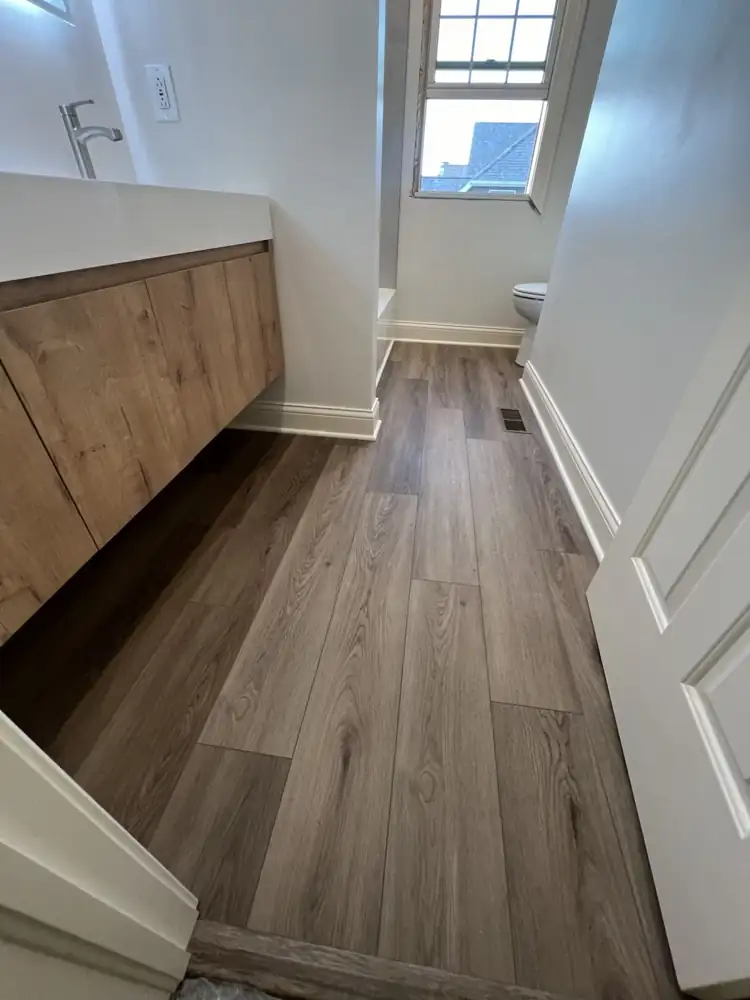 Wood-look luxury vinyl plank floor in a bathroom with floating oak vanity, Northeast Ohio