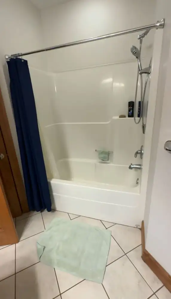 Fiberglass tub and shower unit with curtain before remodel, Northeast Ohio