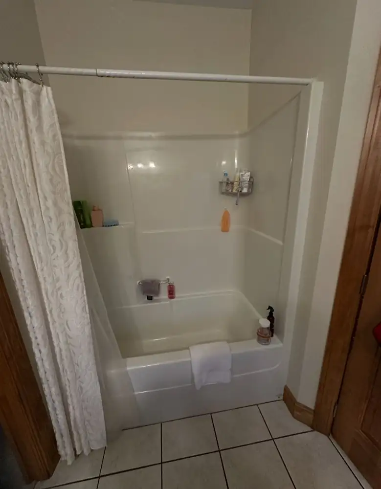Fiberglass tub and shower surround with curtain before remodel, Northeast Ohio