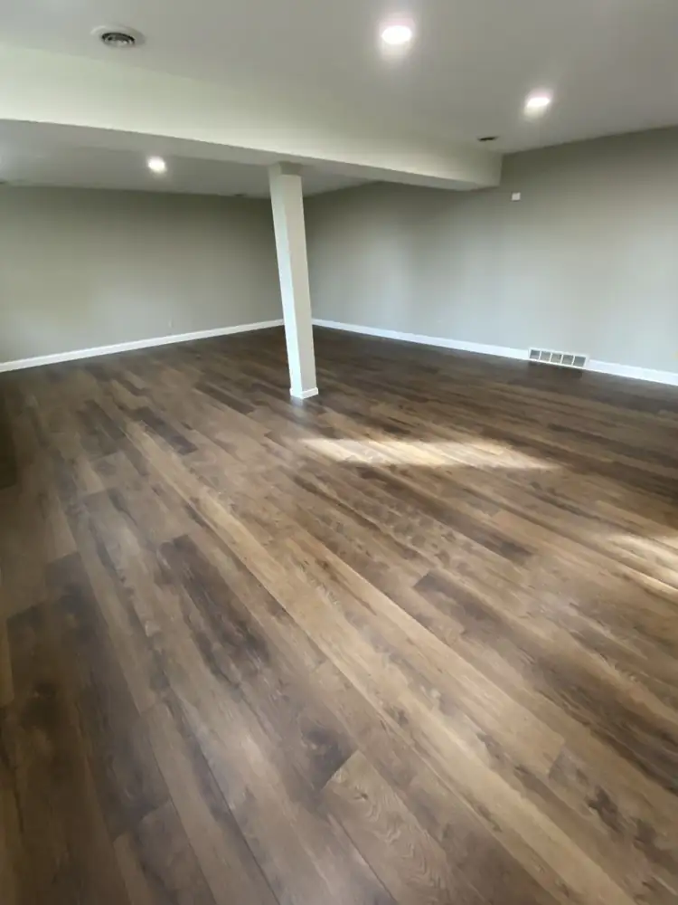 Finished basement with new wide-plank luxury vinyl flooring and recessed lighting, Northeast Ohio