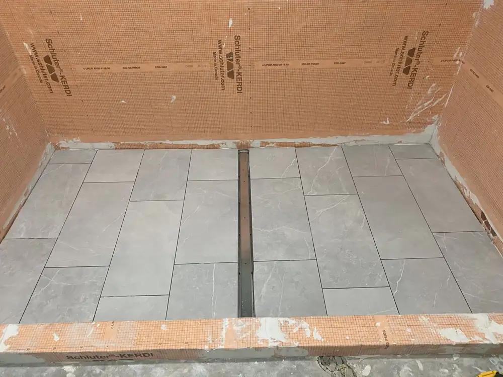 Shower floor waterproofed with Schluter-Kerdi membrane and tiled around a linear drain, Northeast Ohio