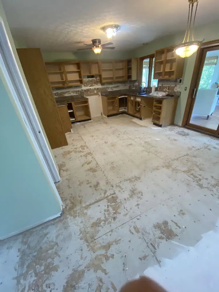 Kitchen and dining floor stripped to the subfloor before new flooring, Northeast Ohio