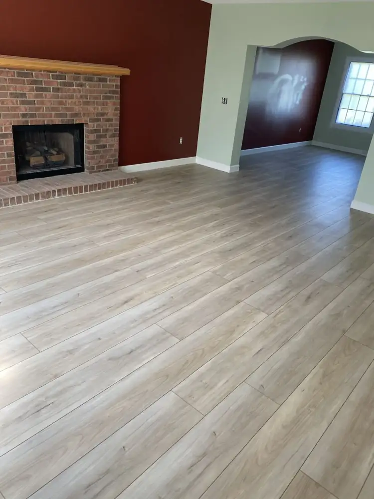 Living room with light oak-look wide-plank flooring running into the dining room, Northeast Ohio