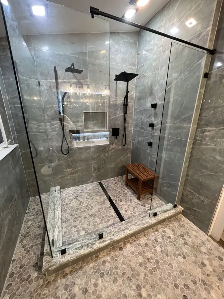 Frameless glass double shower with matte black fixtures, body sprays and teak bench, Northeast Ohio