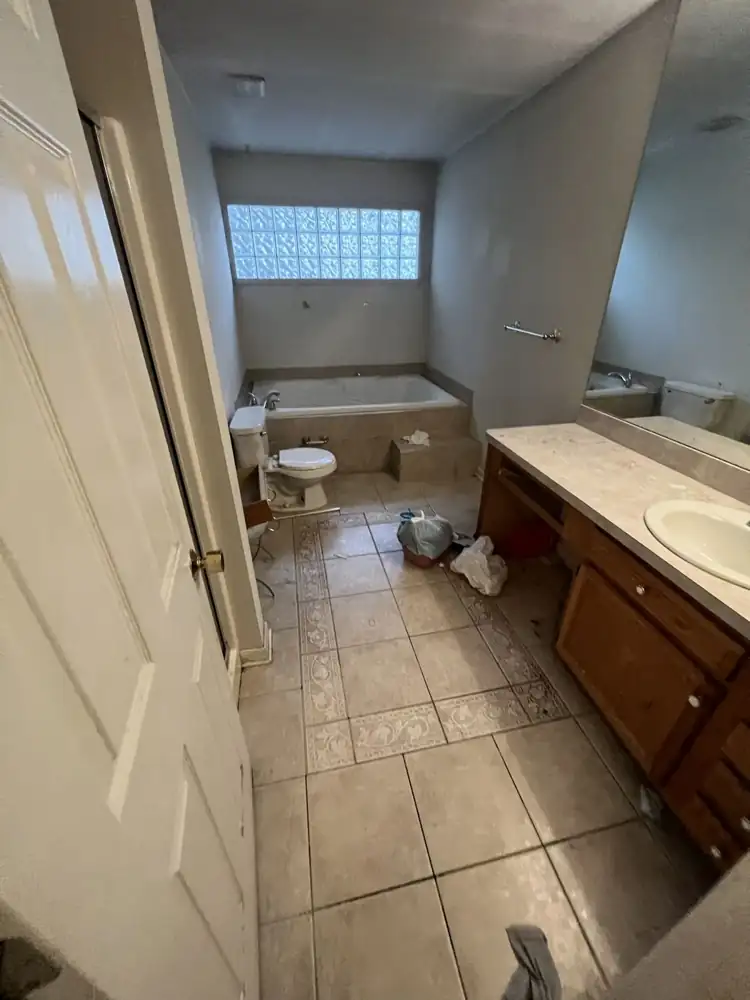 Primary bathroom with jetted tub and dated tile floor before remodel, Northeast Ohio