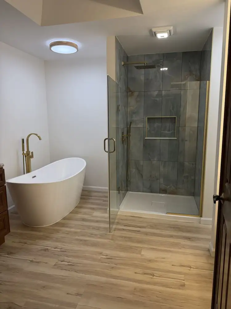 Freestanding tub with brushed gold floor-mount filler and onyx-look shower, North Royalton