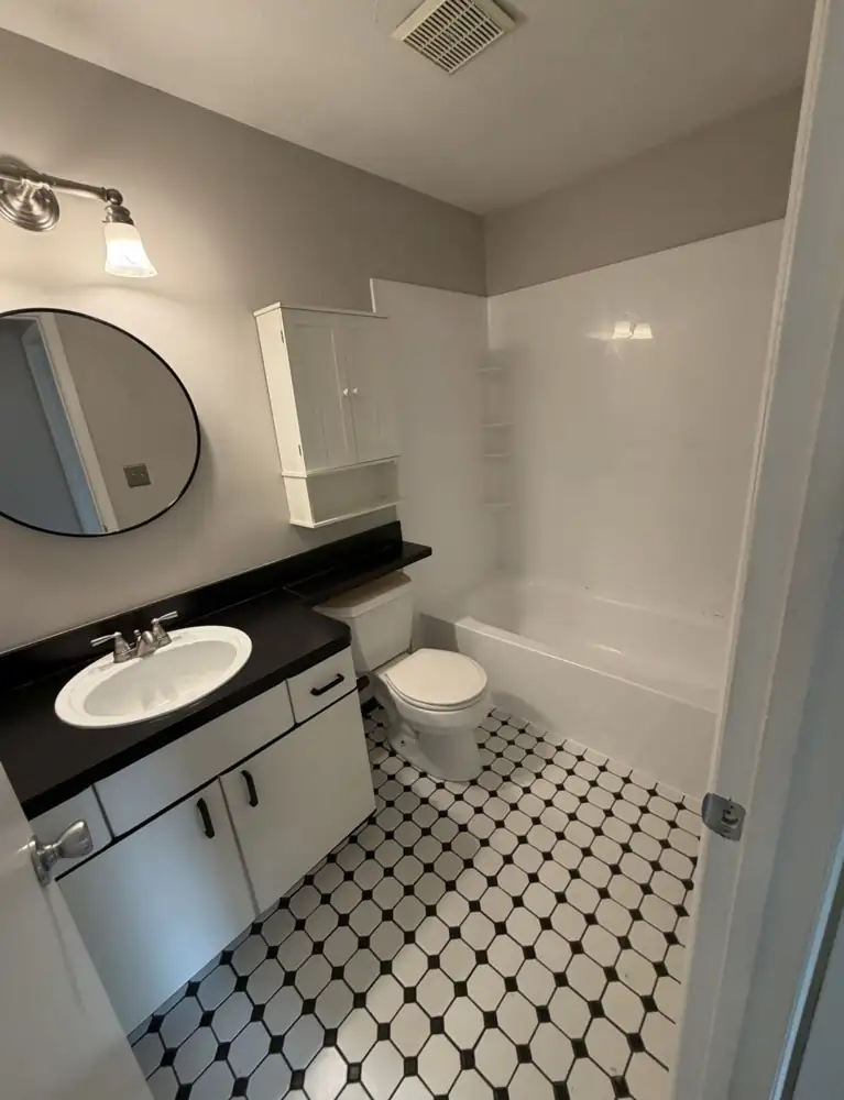 Hall bathroom with fiberglass tub surround and laminate vanity before remodel, Rocky River, Ohio