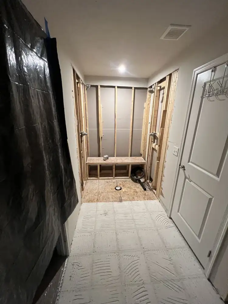 Shower framed with a built-in bench during remodel, Streetsboro, Ohio