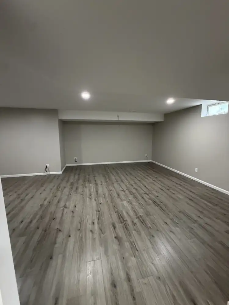 Another view: Finished basement with drywall, recessed lighting, soffits and gray plank flooring, Solon, Ohio