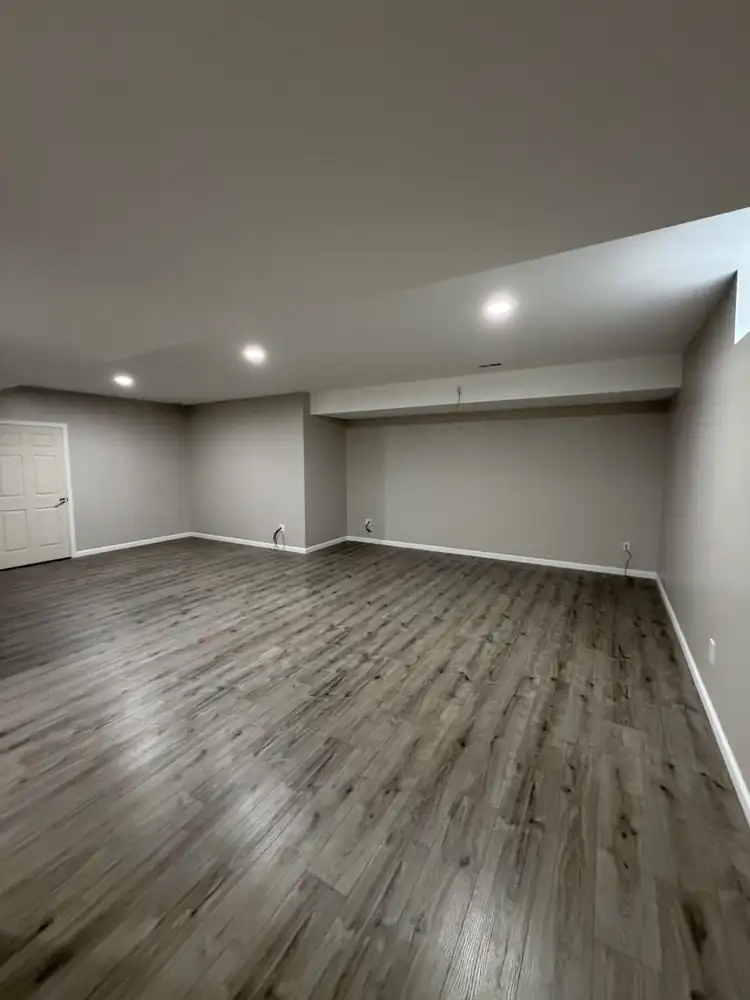 Another view: Finished basement with drywall, recessed lighting, soffits and gray plank flooring, Solon, Ohio