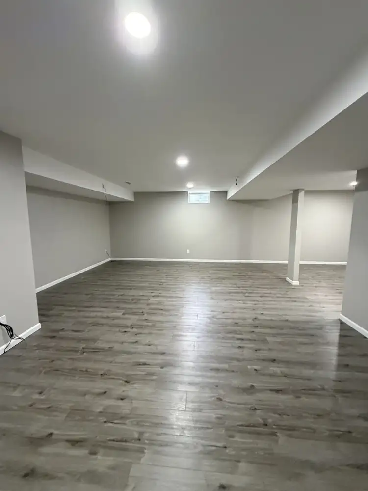 Another view: Finished basement with drywall, recessed lighting, soffits and gray plank flooring, Solon, Ohio