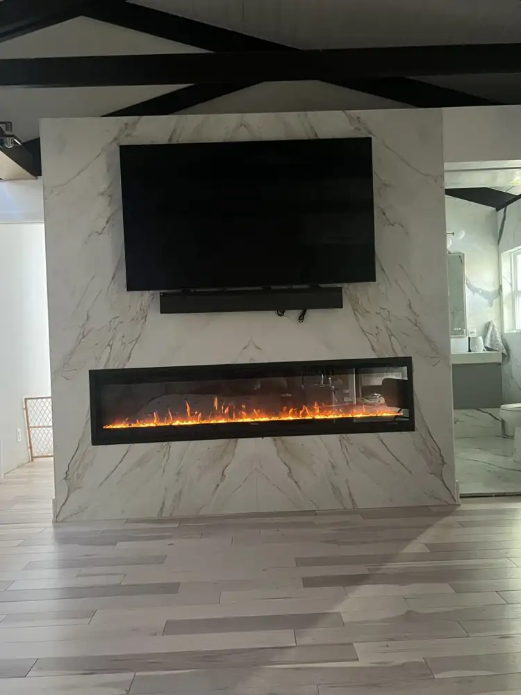 Another view: Bookmatched marble-look porcelain fireplace wall with linear fireplace and TV