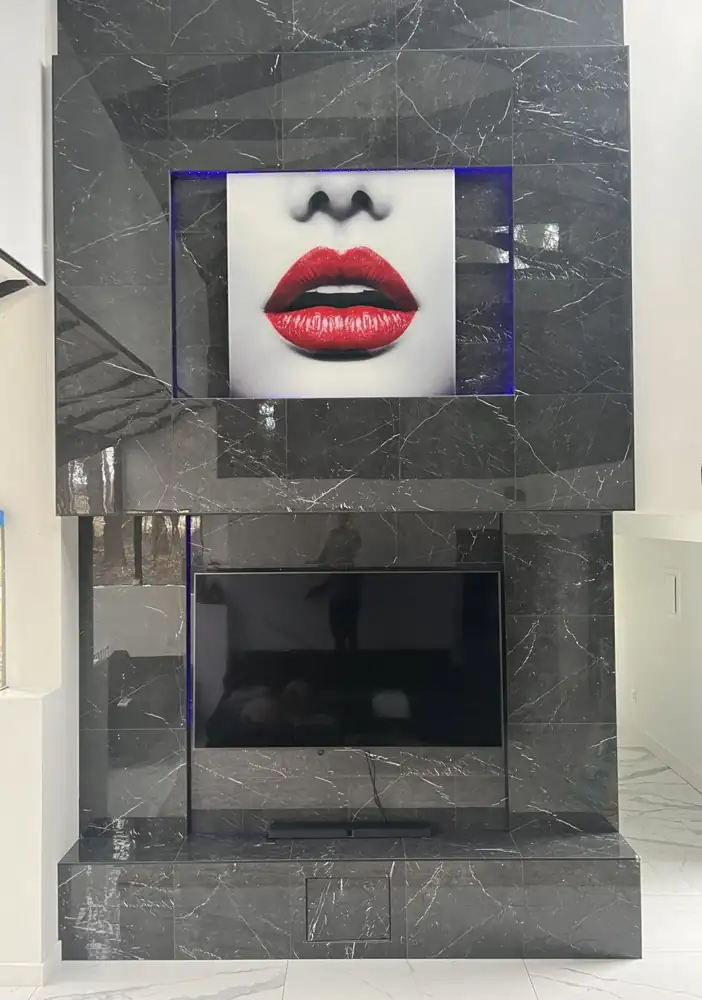 Two-story black marble-look porcelain media wall with lit art niche, Twinsburg